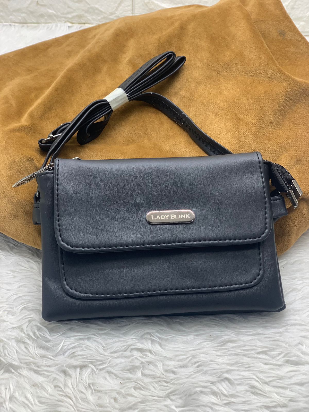 TRENDBUY classic black PU leather sling bag, front view with textured finish.