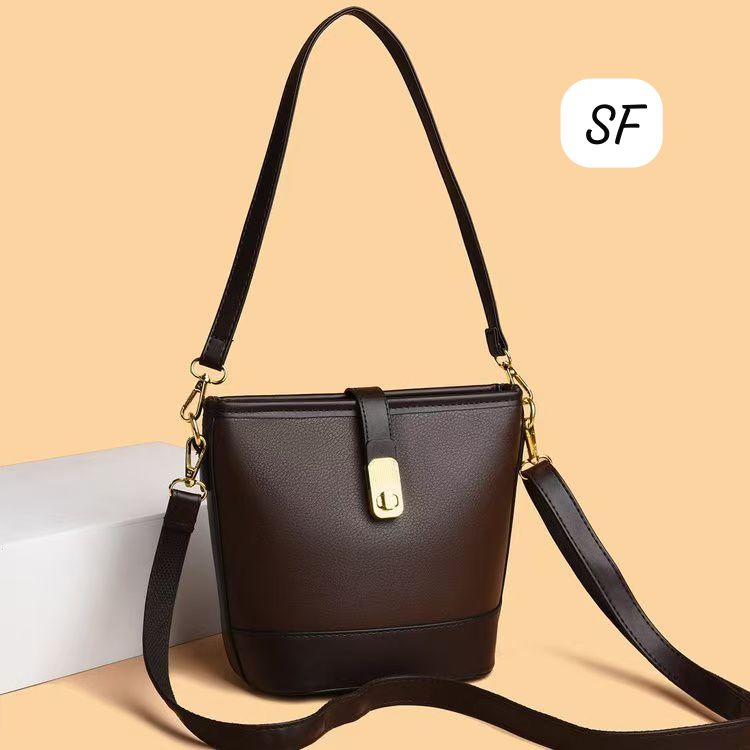 Dark brown elegant sling bag with adjustable strap and sophisticated golden buckle.