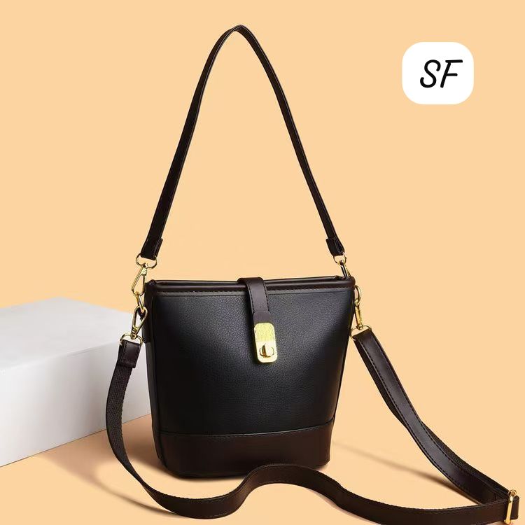 Black and dark brown sling bag with an extended crossbody strap for versatile wear.