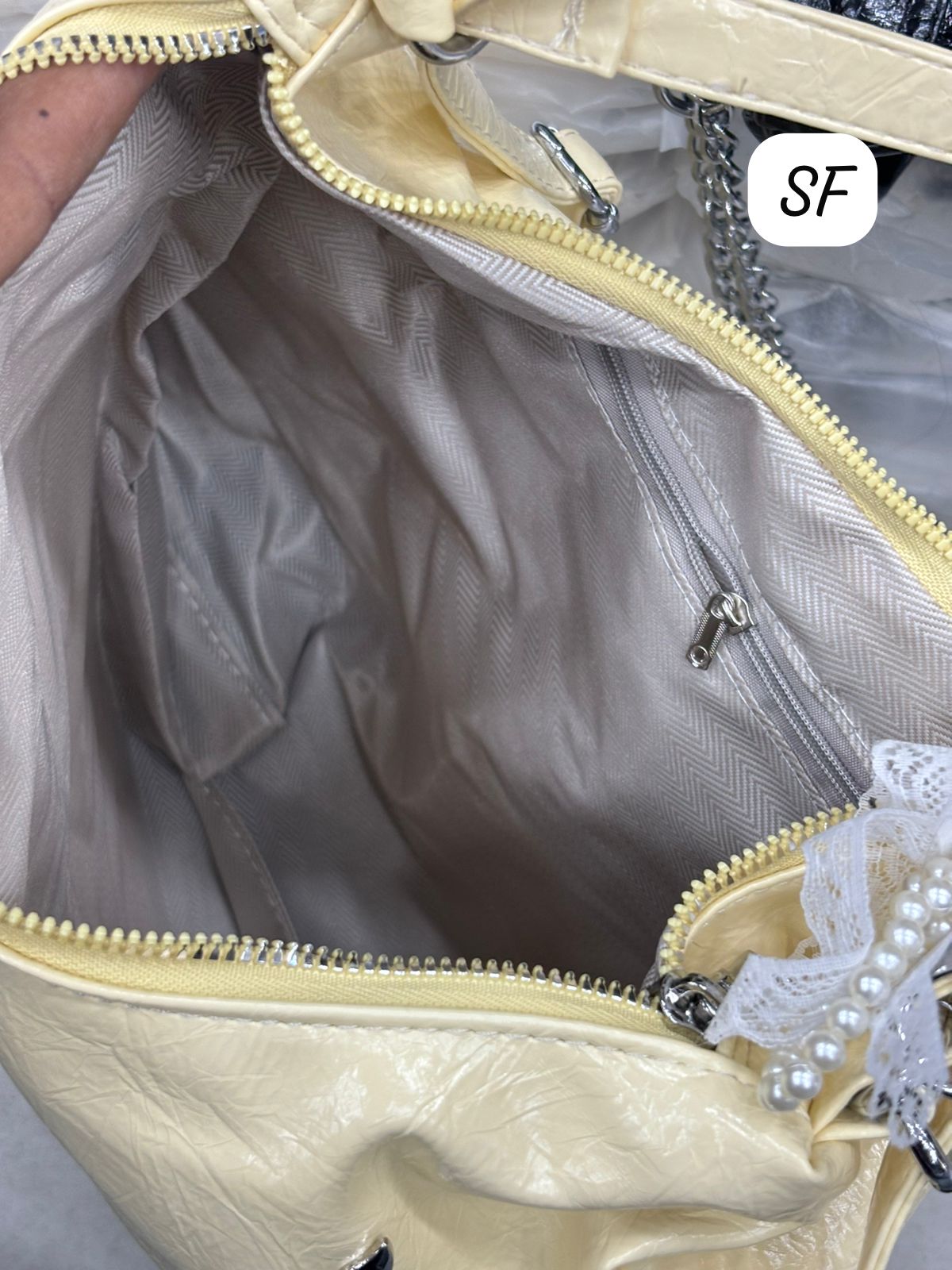 Interior view of the TRENDBUY convertible bag, showing a spacious main compartment and a secure zipper pocket.