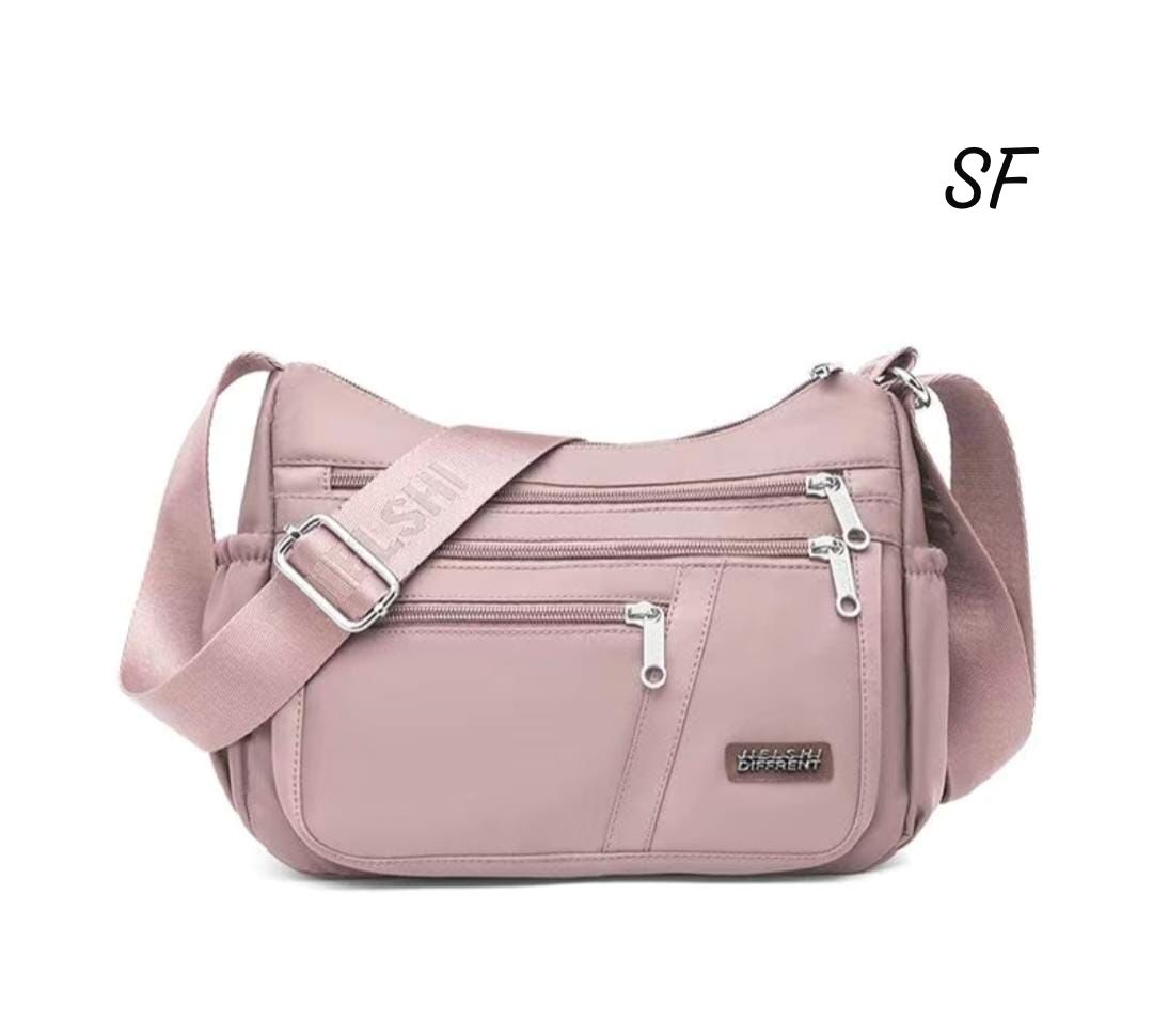 TRENDBUY Dusty Pink Imported Sling Bag showcasing front zippered pockets and elegant silver hardware.