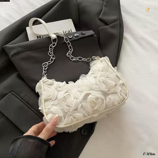 TRENDBUY Charles & Keith style 3D rose textured sling bag in white, displayed on a dark blazer.