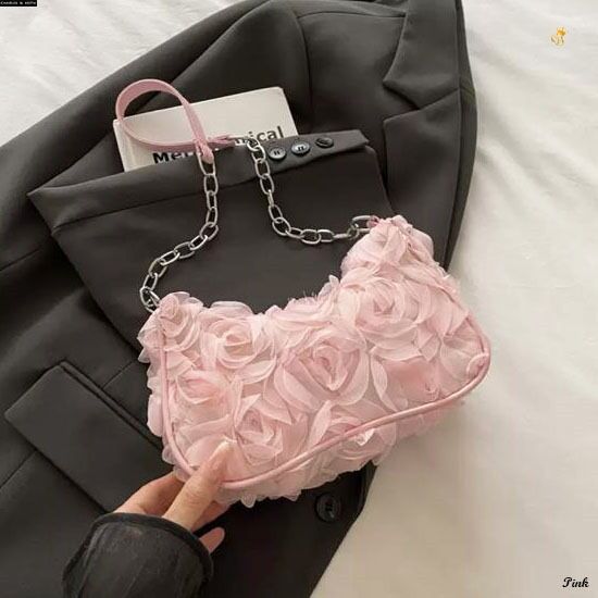 TRENDBUY Charles & Keith style 3D rose textured sling bag in pink, displayed on a dark blazer.