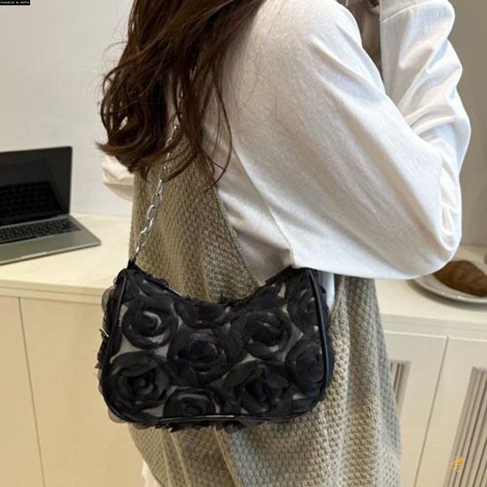 Model wearing TRENDBUY Charles & Keith style 3D rose textured black sling bag, viewed from the back.
