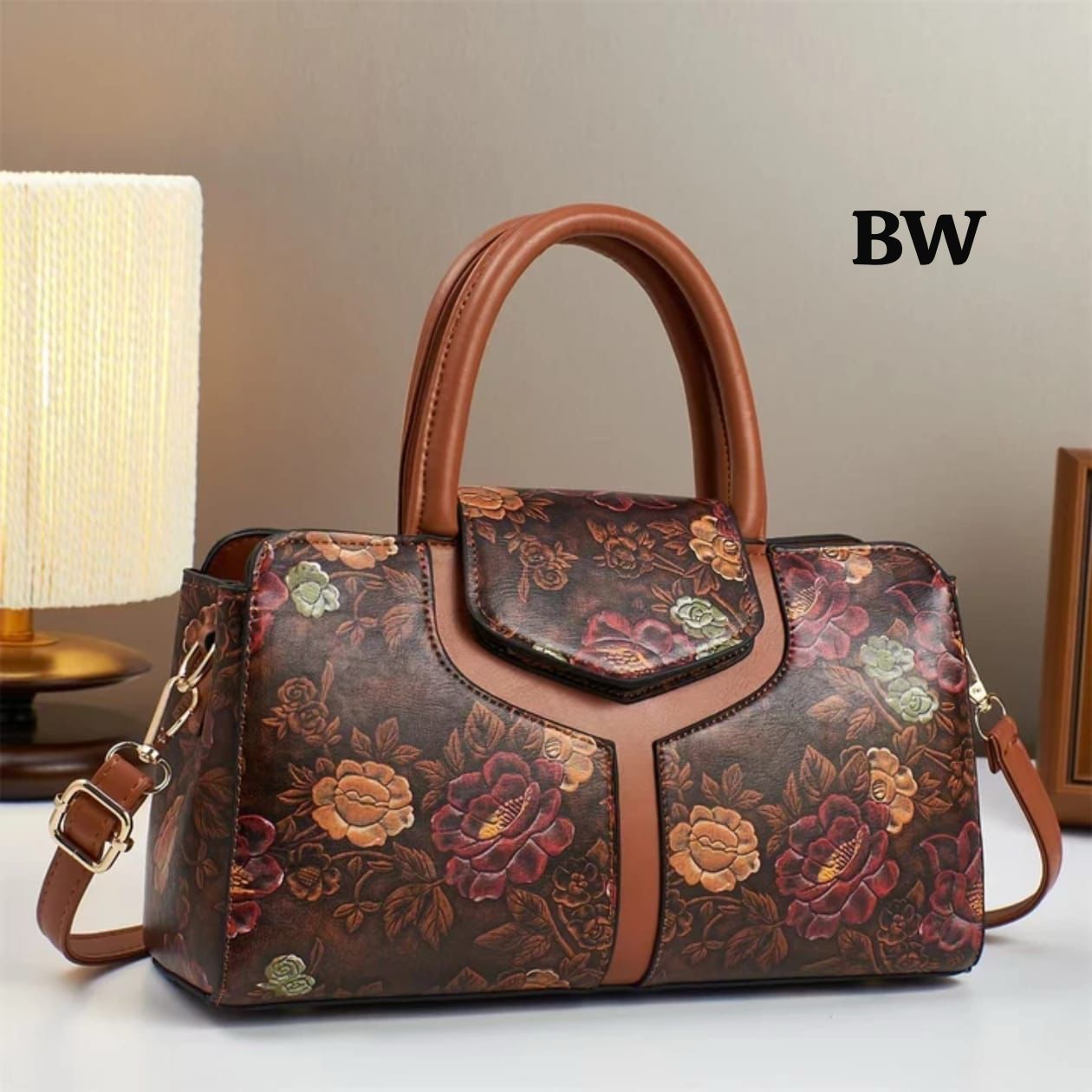 TRENDBUY premium floral handbag in brown with tan handles and a long adjustable strap, styled on a minimalist table.
