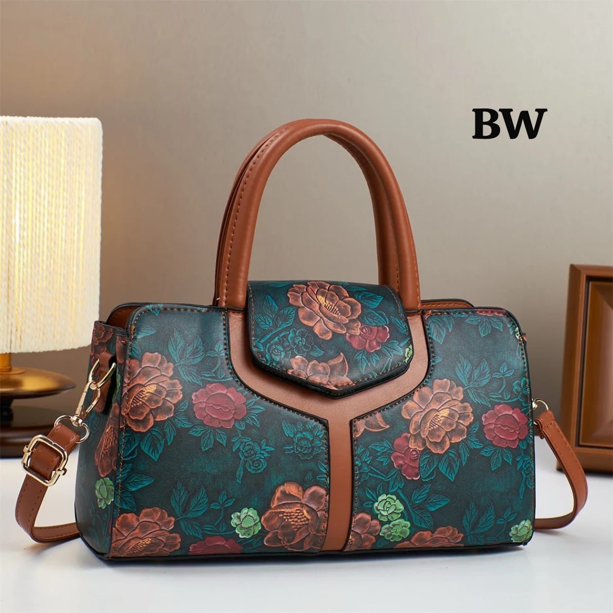 TRENDBUY premium floral handbag in teal with tan handles and a long adjustable strap, displayed elegantly on a white surface.