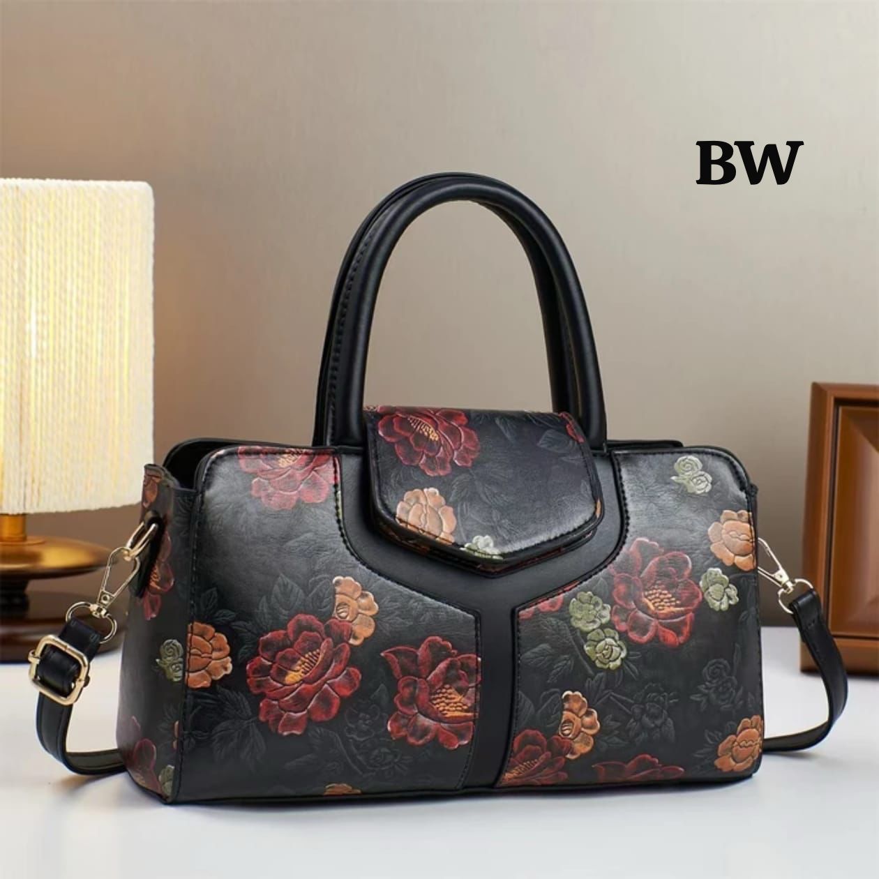 TRENDBUY premium floral handbag in black with black handles and a long adjustable strap, featuring vibrant floral patterns.