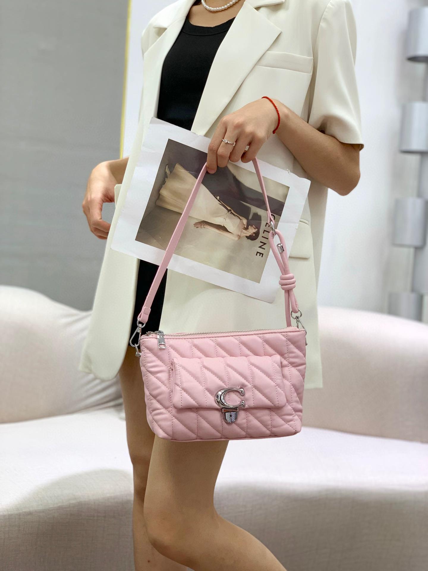 TRENDBUY Premium Quilted Dual Belt Sling Bag in Pink, held by model