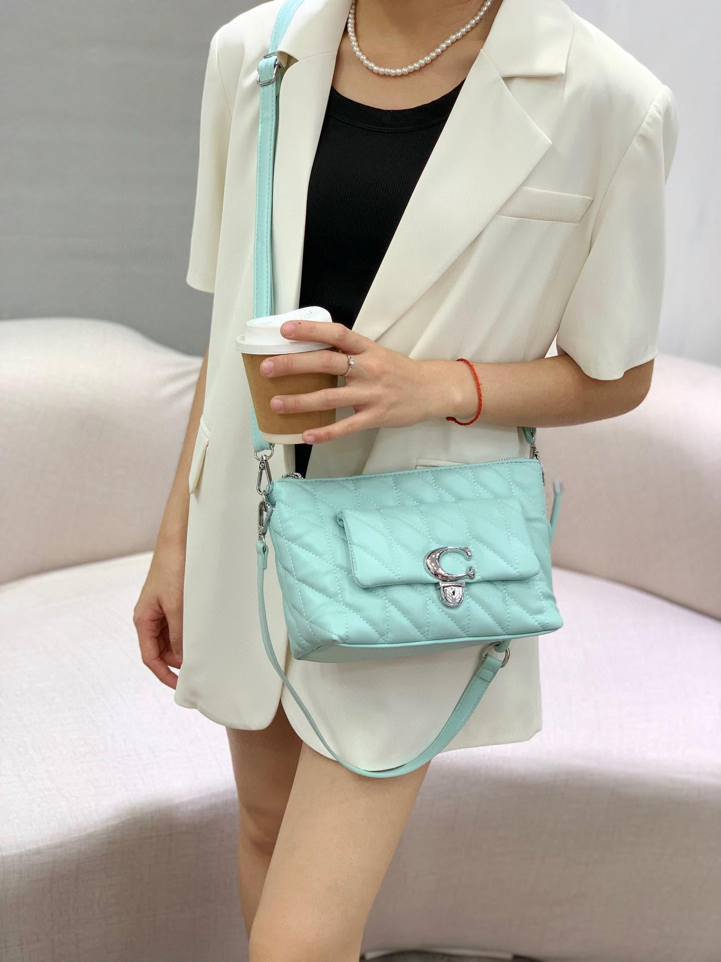 TRENDBUY Premium Quilted Dual Belt Sling Bag in Mint Green, worn by model holding coffee