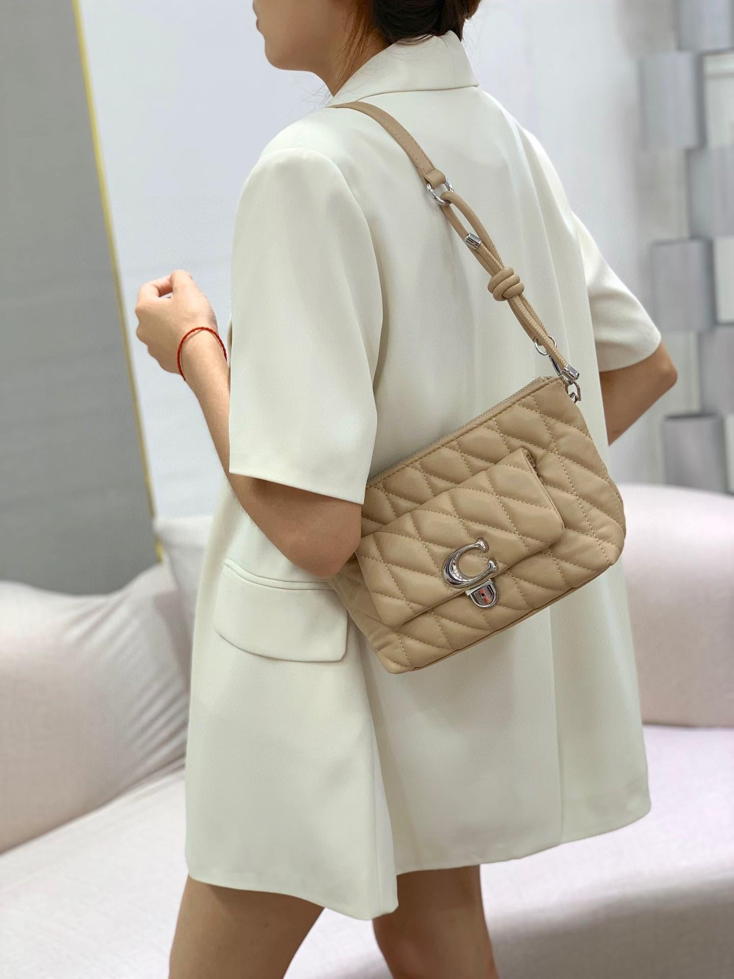TRENDBUY Premium Quilted Dual Belt Sling Bag in Beige, styled on model's back