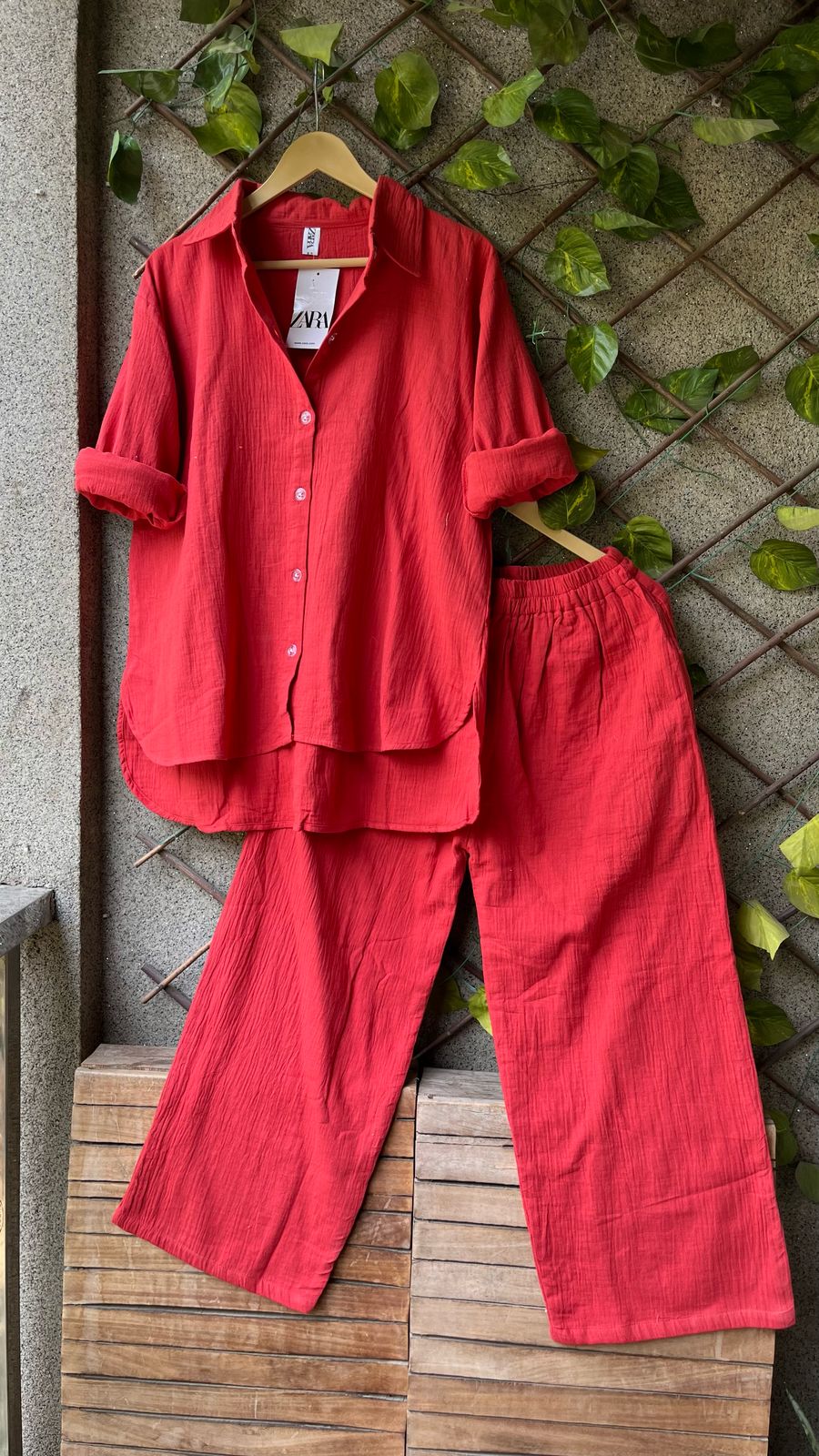 Striking Red Updown Mul Mul Cotton Cord Set, featuring a Zara tag, against lush green wall decor.