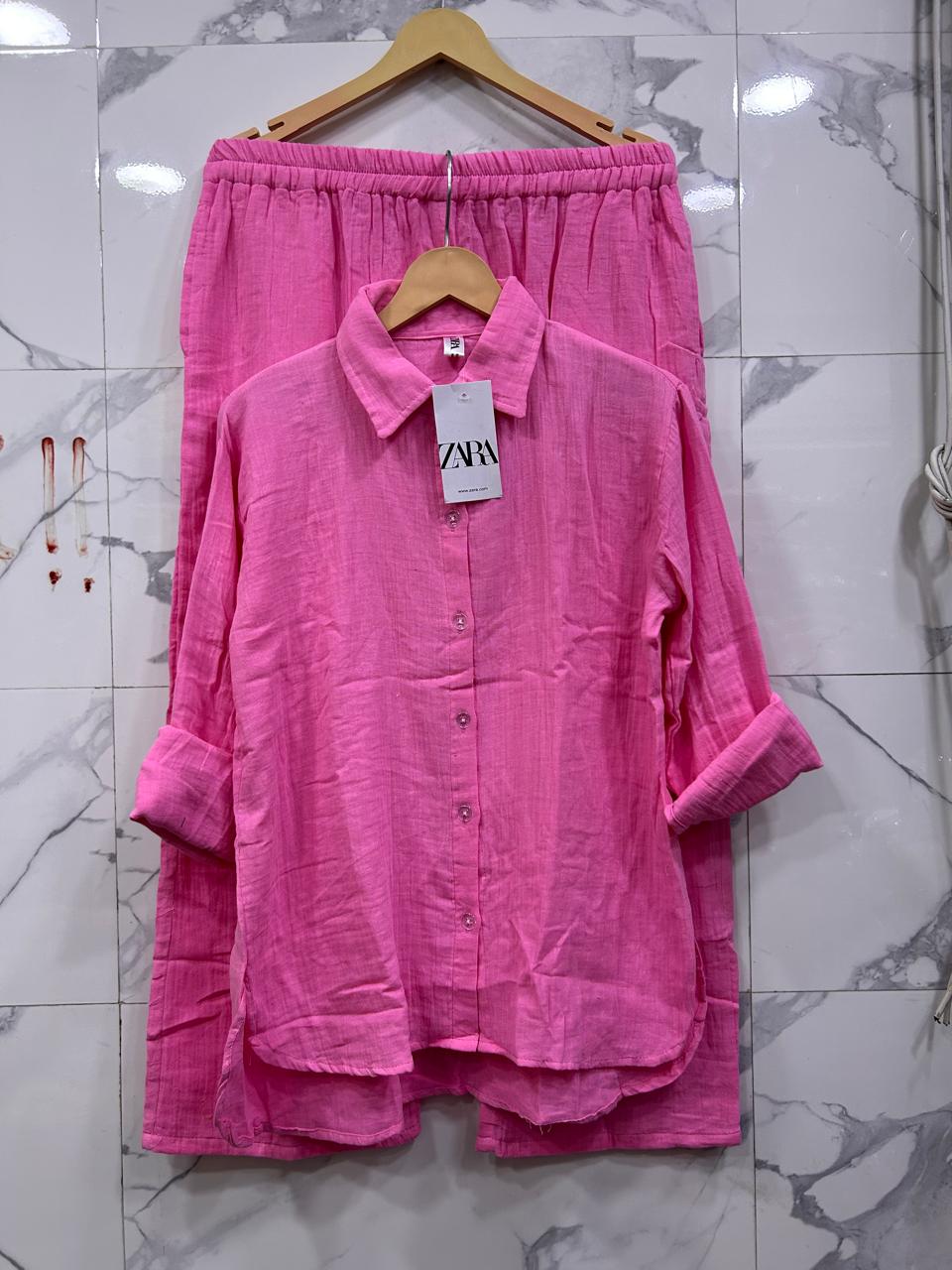 Full view of Hot Pink Mul Mul Cotton Cord Set, with a Zara tag, vibrant and flowy on marble backdrop.