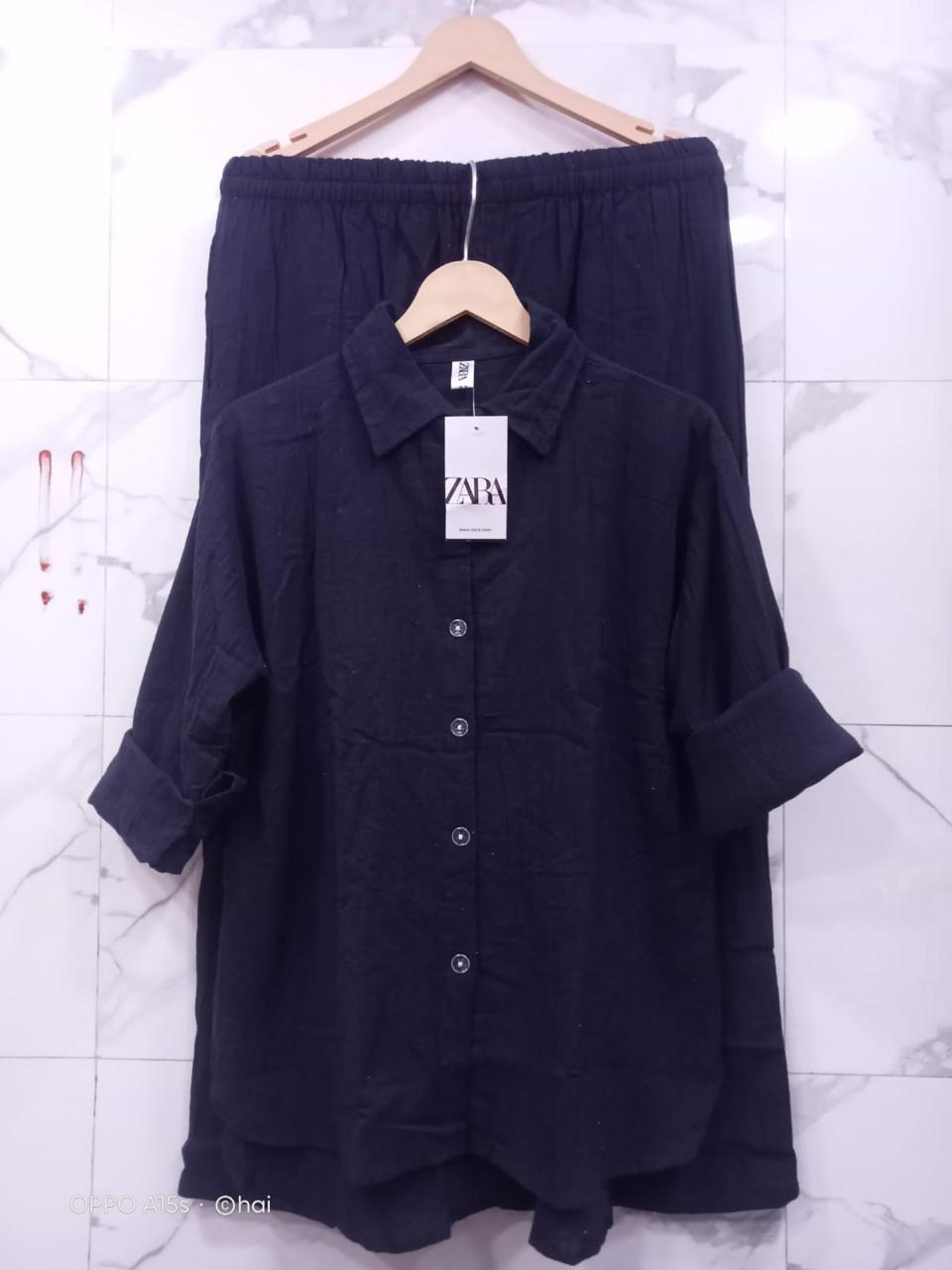 Alternate full view of Black Mul Mul Cotton Cord Set, highlighting fabric texture on a marble wall.