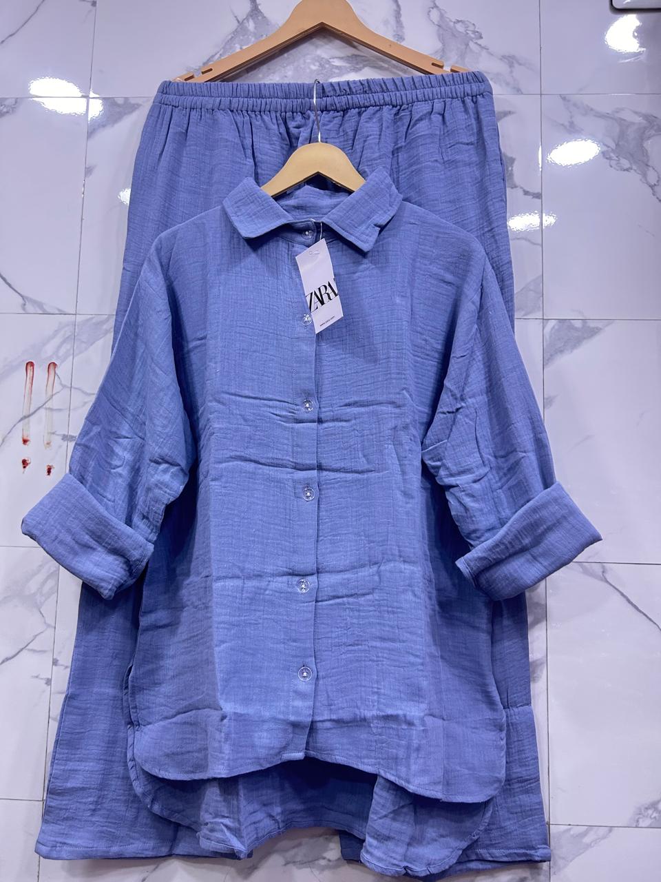 Full view of Light Blue Mul Mul Cotton Cord Set, presenting a soothing color palette on marble.