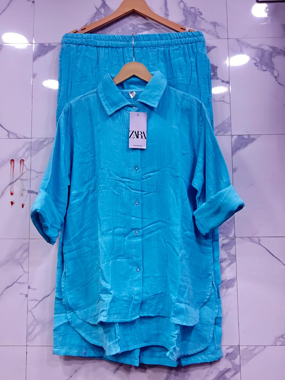 Full view of Ice Blue Mul Mul Cotton Cord Set, with Zara tag, on a white tiled background.