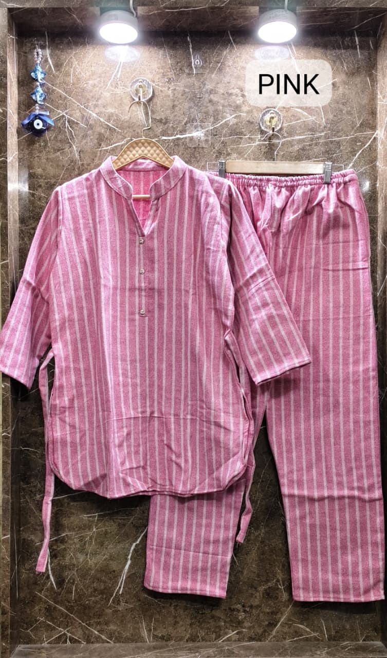 Flat lay of TRENDBUY pink striped cotton fleece cord set, featuring top with collar and pants with pocket.