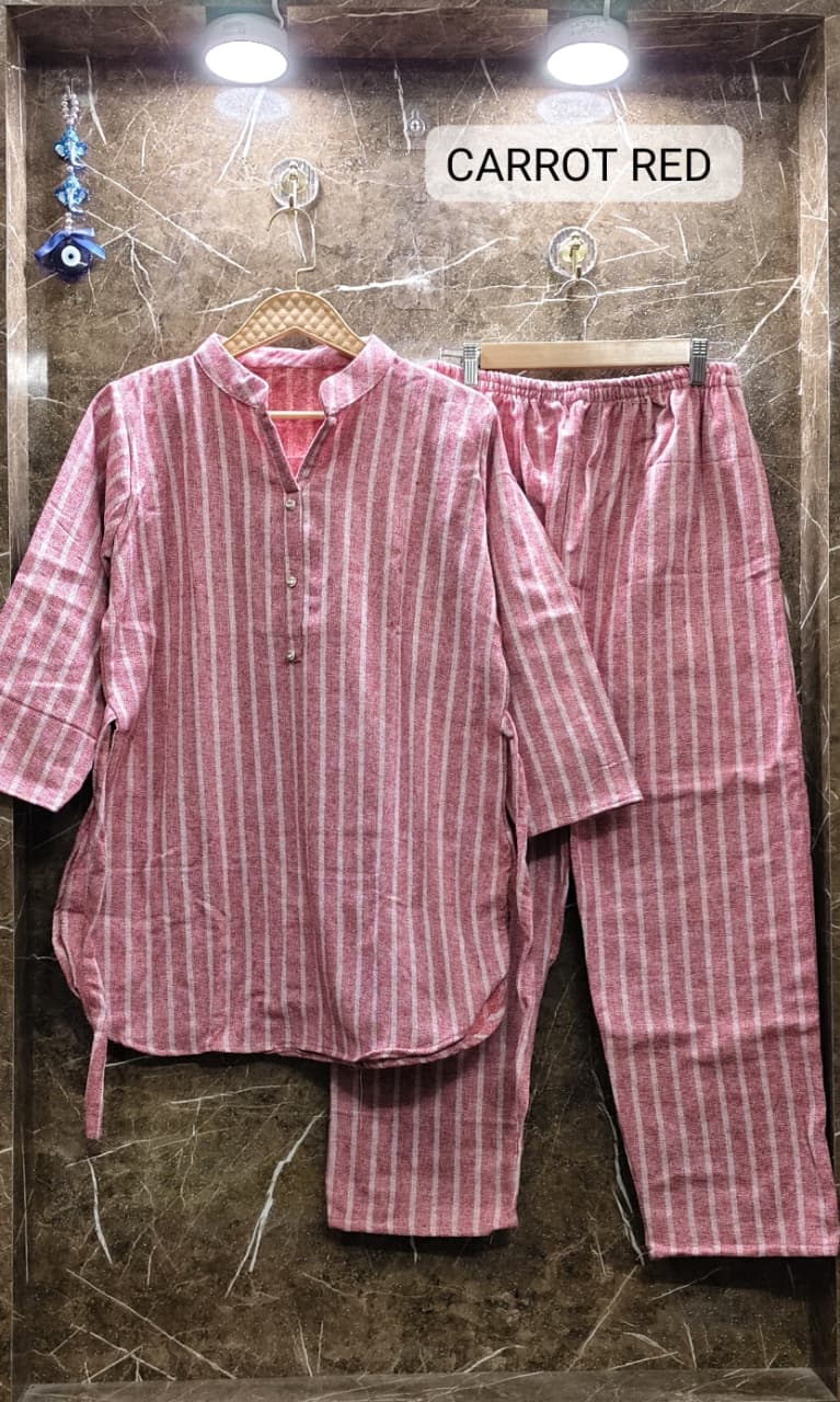 Flat lay of TRENDBUY carrot red striped cotton fleece cord set, highlighting the vibrant color and soft texture.