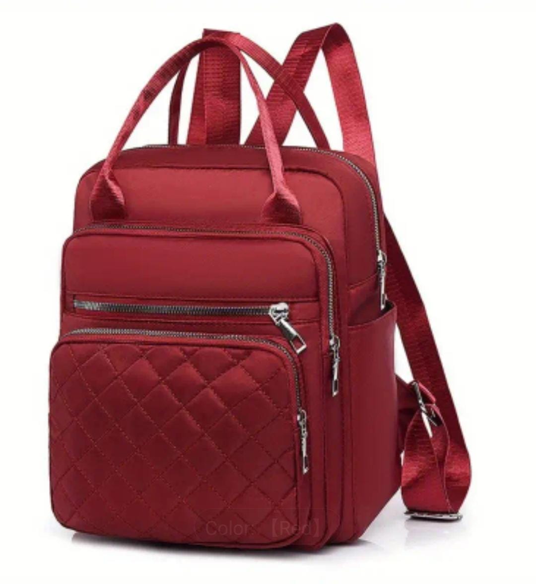 Detailed angled shot of the red quilted nylon backpack, clearly showing the 'Red' color variant.