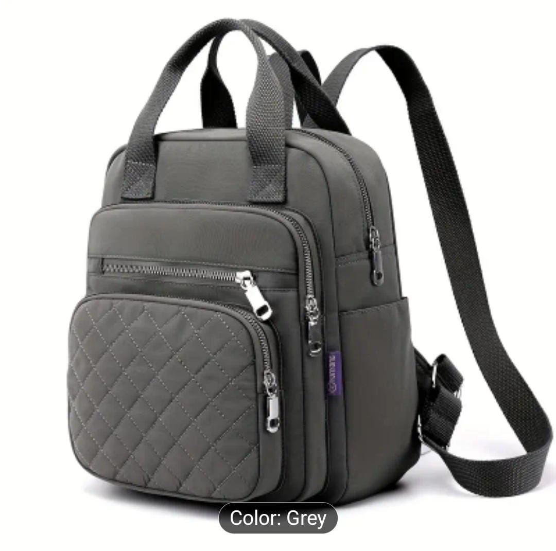 Angled side view of the grey quilted nylon backpack, explicitly labeling the 'Grey' color option.
