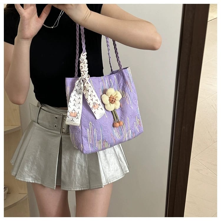 Woman in a silver skirt carrying a TRENDBUY purple floral charm tote bag