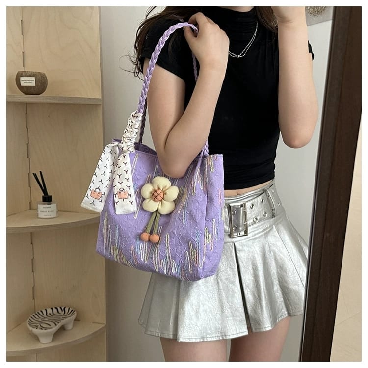 Side profile of a woman holding a TRENDBUY purple floral charm tote bag