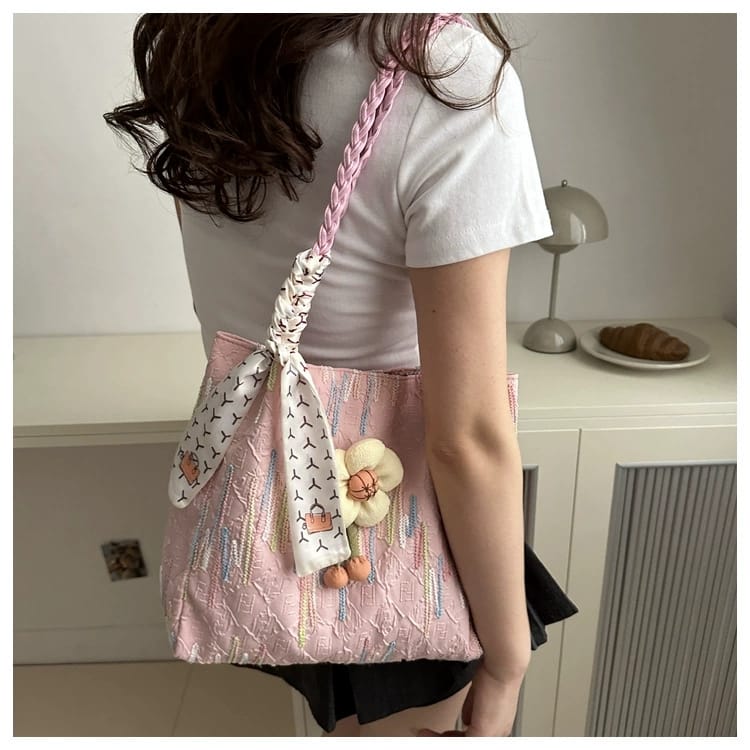 Woman from behind, carrying a TRENDBUY pink floral charm tote bag over her shoulder