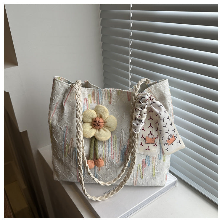 Close-up of TRENDBUY white floral charm tote bag with braided handle and scarf detail