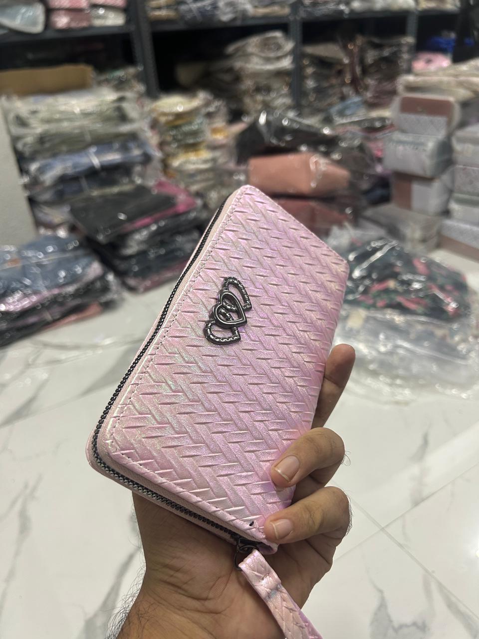 Close-up of TRENDBUY Dhup Chhao wallet, displaying light pink iridescent hues and a heart-shaped metallic embellishment.