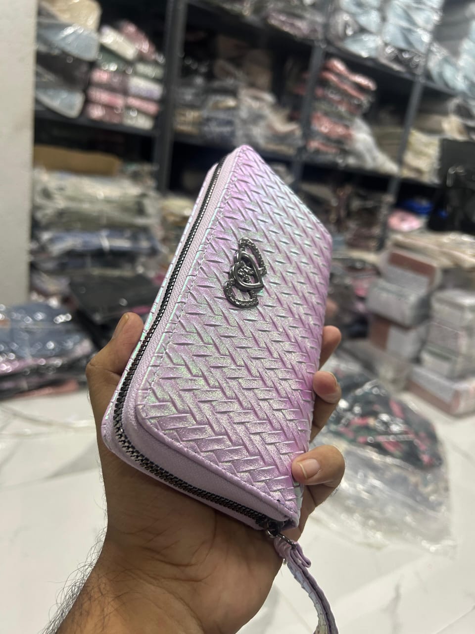Angled view of TRENDBUY iridescent wallet in Lavender, emphasizing the woven texture and secure zipper.