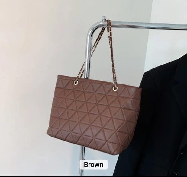 TRENDBUY brown rhombus quilted tote bag hanging on a rack, showcasing the rich brown color