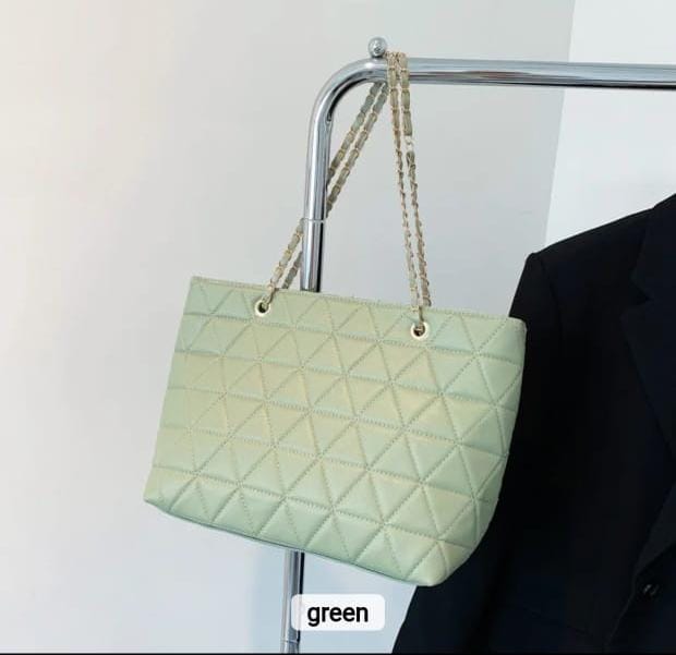 TRENDBUY light green rhombus quilted tote bag hanging on a rack, highlighting the soft green hue