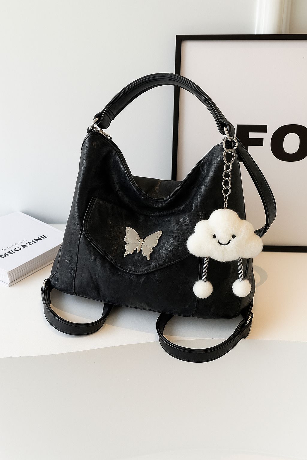 TRENDBUY black premium butterfly designer tote backpack with a white cloud charm, displayed elegantly on a shelf.