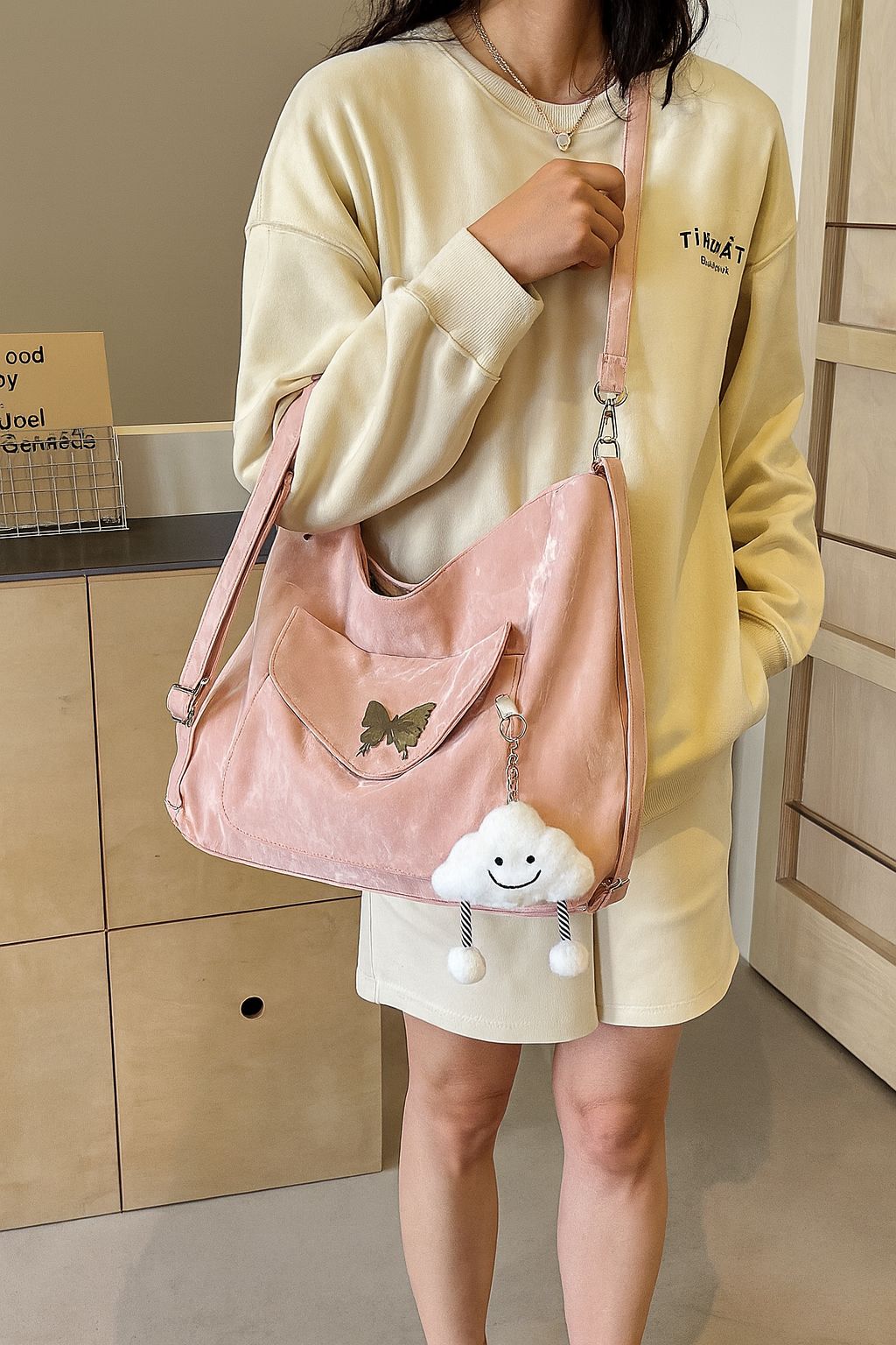 Woman wearing a casual outfit, showcasing the TRENDBUY pink premium butterfly designer tote backpack as a shoulder bag.