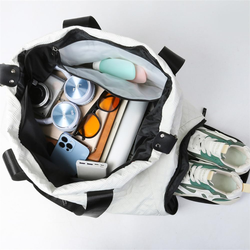 Overhead view of a white quilted duffle bag open, filled with travel essentials like headphones, phone, and sunglasses, with a separate shoe compartment holding sneakers.