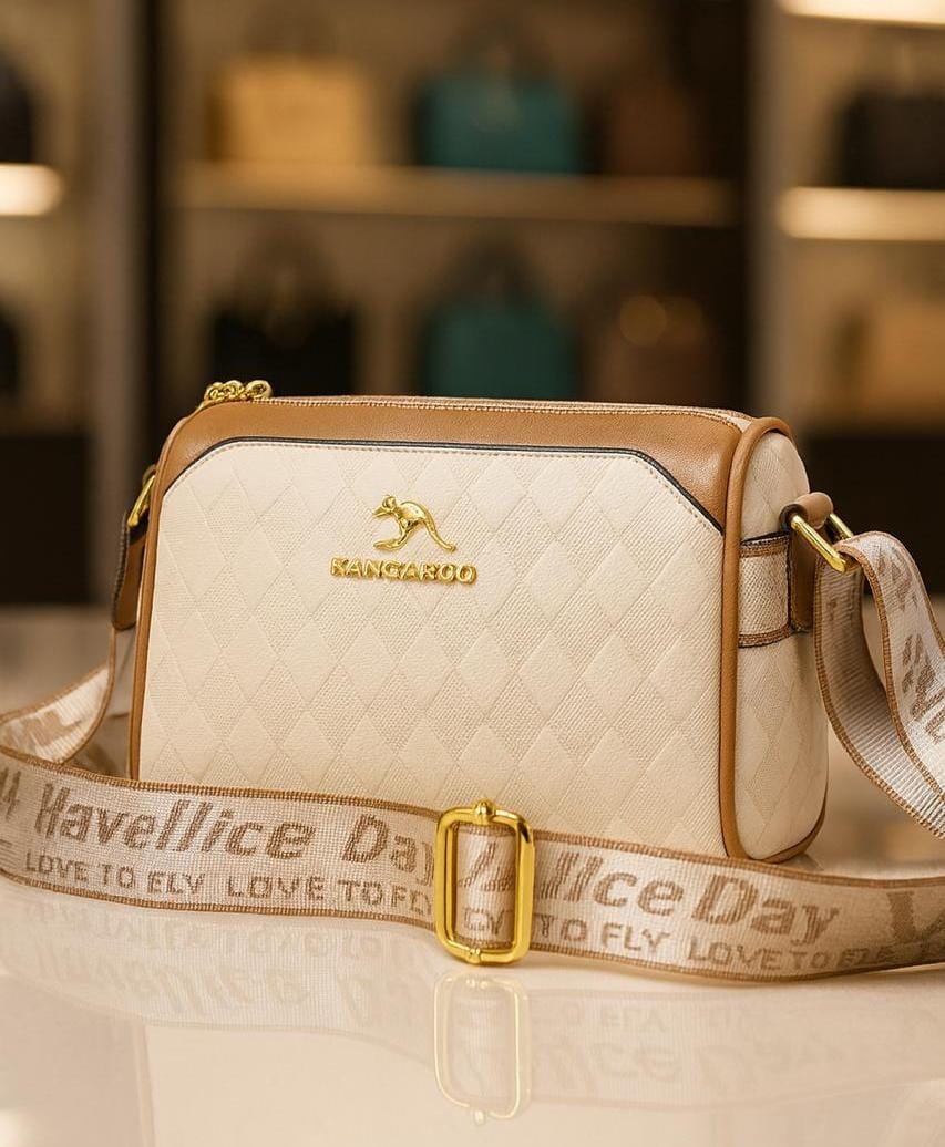 TRENDBUY women's geometric Boston sling bag in cream with gold kangaroo logo and patterned strap. Front view.