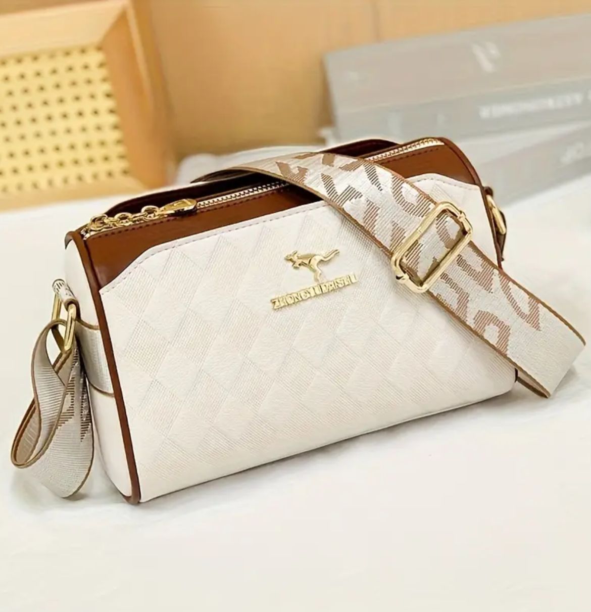 Close-up angled shot of TRENDBUY cream geometric crossbody bag, highlighting textured PU material and logo.