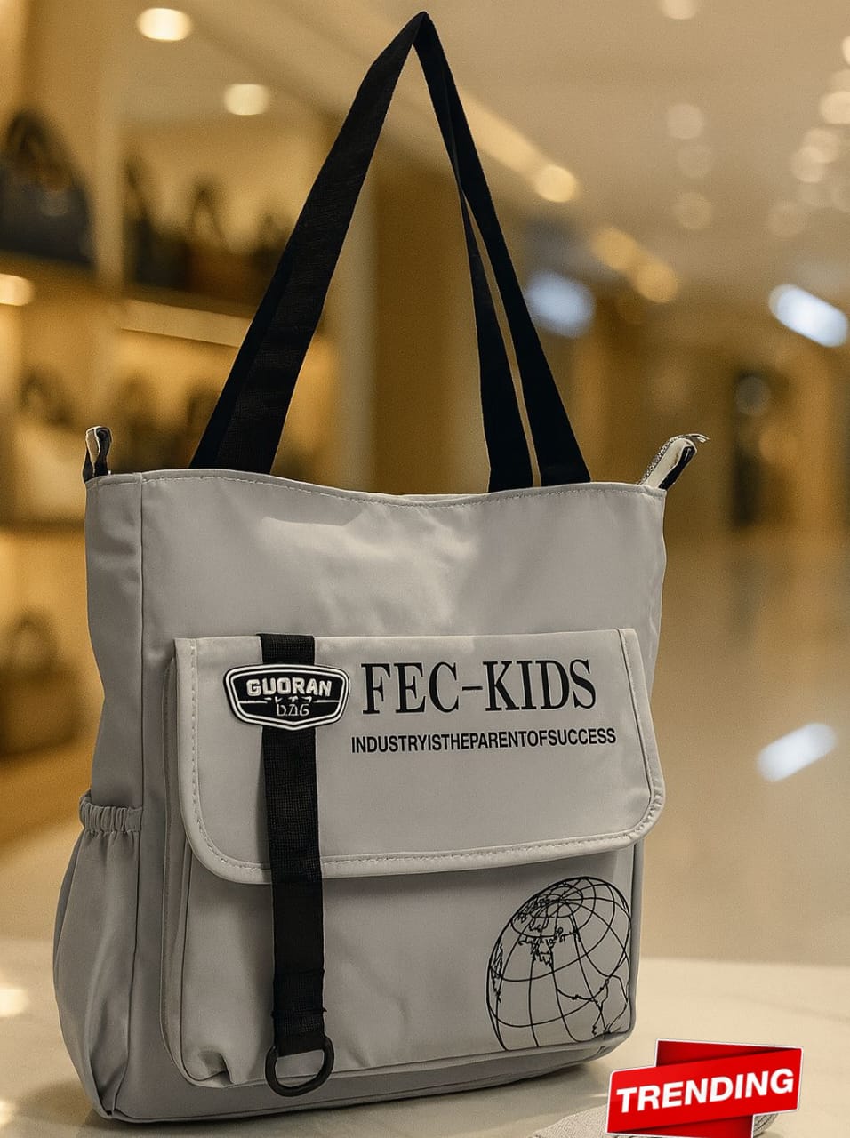 Light gray imported tote side bag with front flap pocket and globe graphic, TRENDBUY trending.