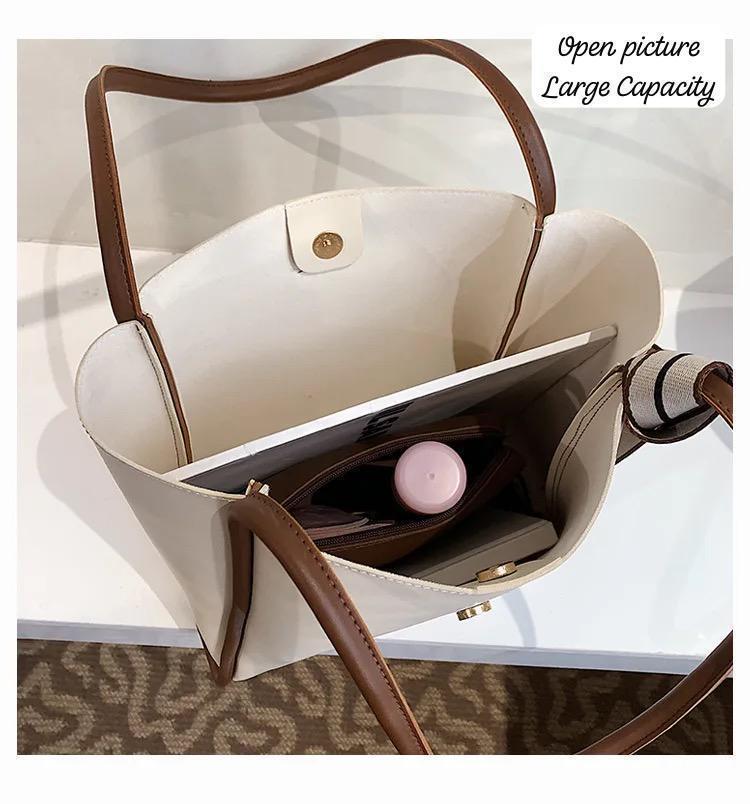 Top-down view inside the TRENDBUY cream PU leather tote bag, showcasing its large capacity with a laptop, water bottle, and accessories inside.