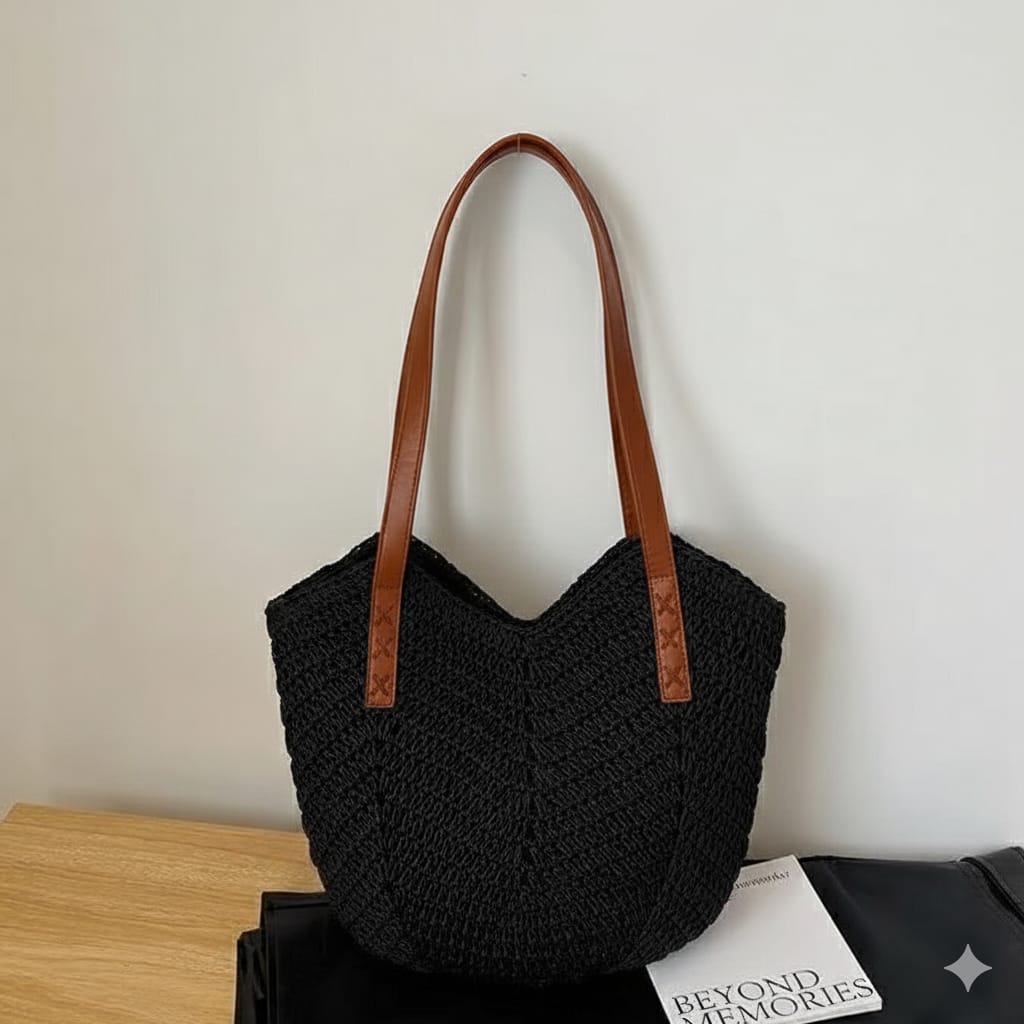 Black TRENDBUY woven tote bag with elegant brown leather-look handles, standing against a white wall.