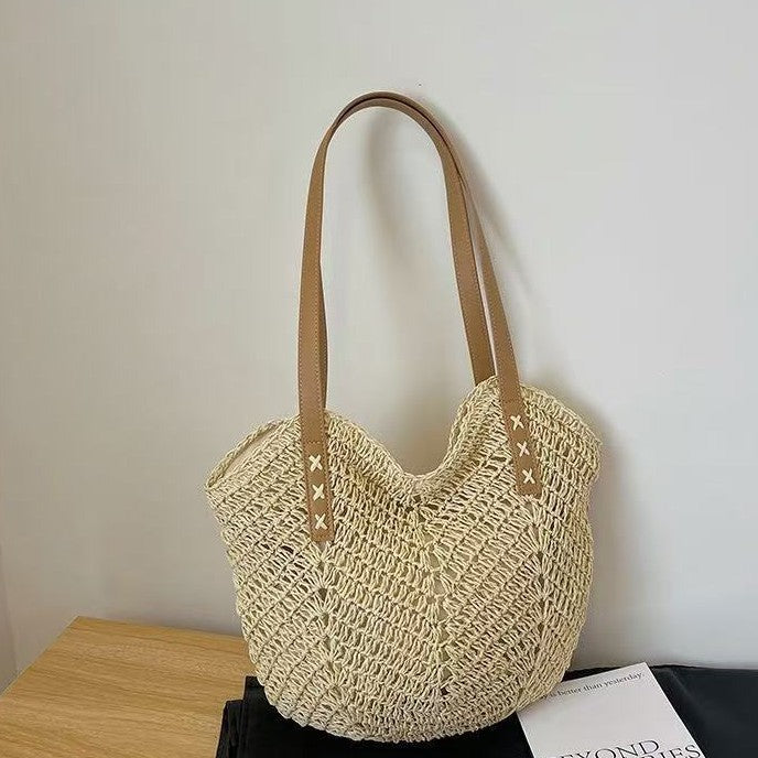 Light beige TRENDBUY woven tote bag with sturdy brown leather-look handles, highlighting its intricate open weave pattern.