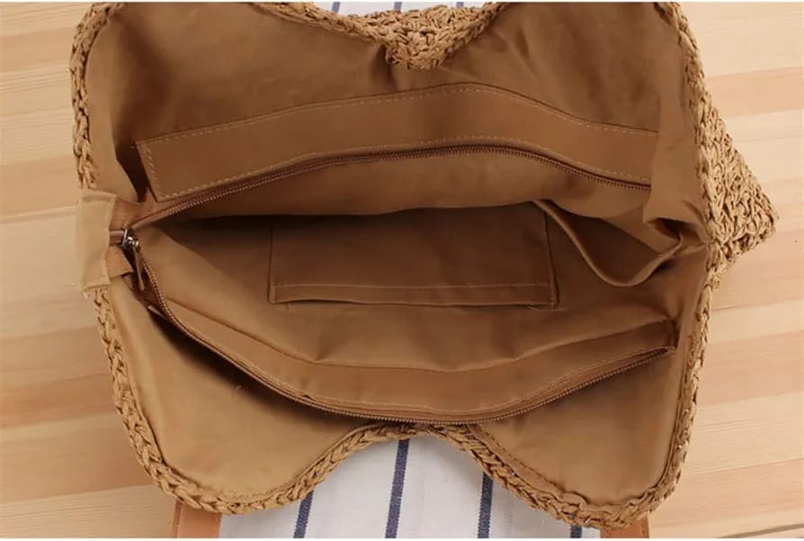 Interior view of the TRENDBUY woven tote bag, revealing a spacious main compartment with a zippered pocket and an additional slip pocket for organization.