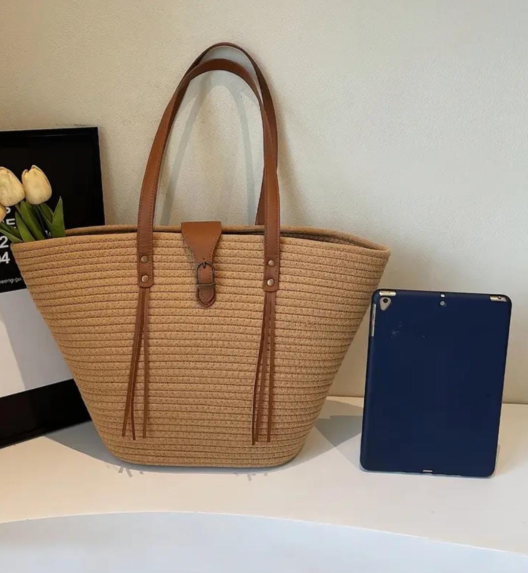 TRENDBUY beige straw weave tote bag displayed alongside a blue tablet for scale, highlighting its practical size.
