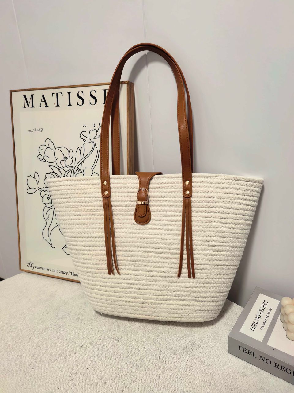 Angled view of the TRENDBUY white woven tote bag, emphasizing the craftsmanship and sturdy design elements.