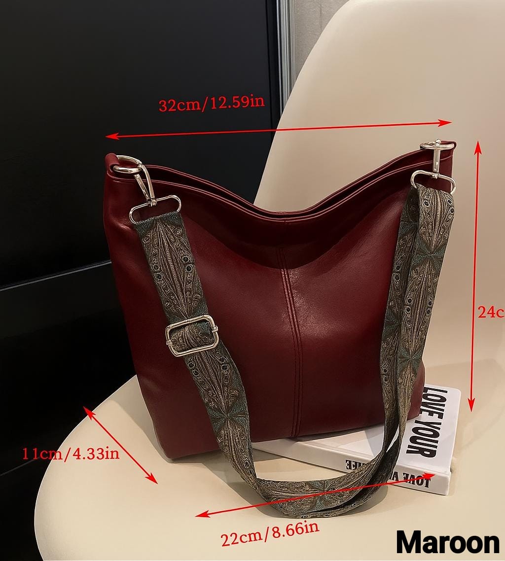 Maroon TRENDBUY PU leather tote bag with dimensions (32cm/12.59in width, 24cm height, 22cm/8.66in depth, 11cm/4.33in base) and decorative strap on a chair.
