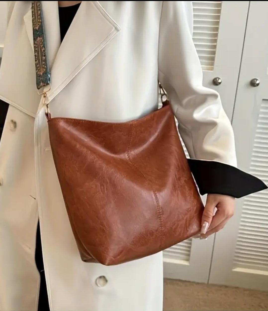 Model wearing a white coat and black top, carrying a brown TRENDBUY PU leather tote bag over her shoulder.