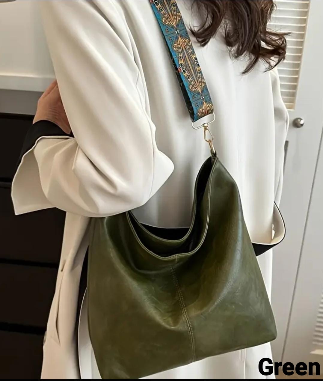 Side view of a model in a white coat, carrying a green TRENDBUY PU leather tote bag across her body.