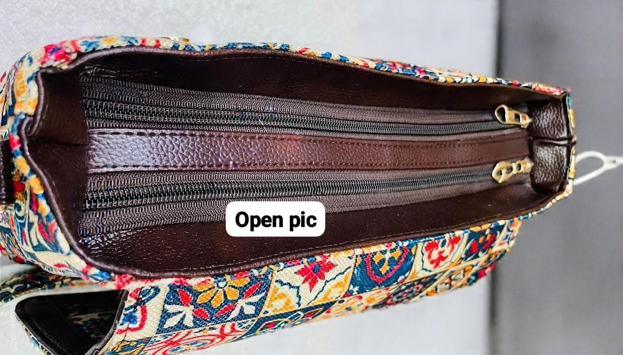Close-up interior view of the TRENDBUY Ikkat Cotton Sling Bag, showing multiple secure zipper compartments in dark brown.