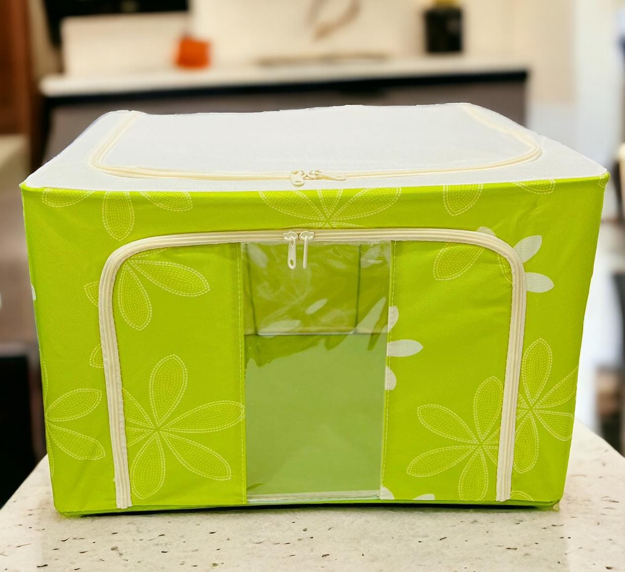 Bright green floral patterned fabric storage box with white zippers, vibrant and eye-catching.