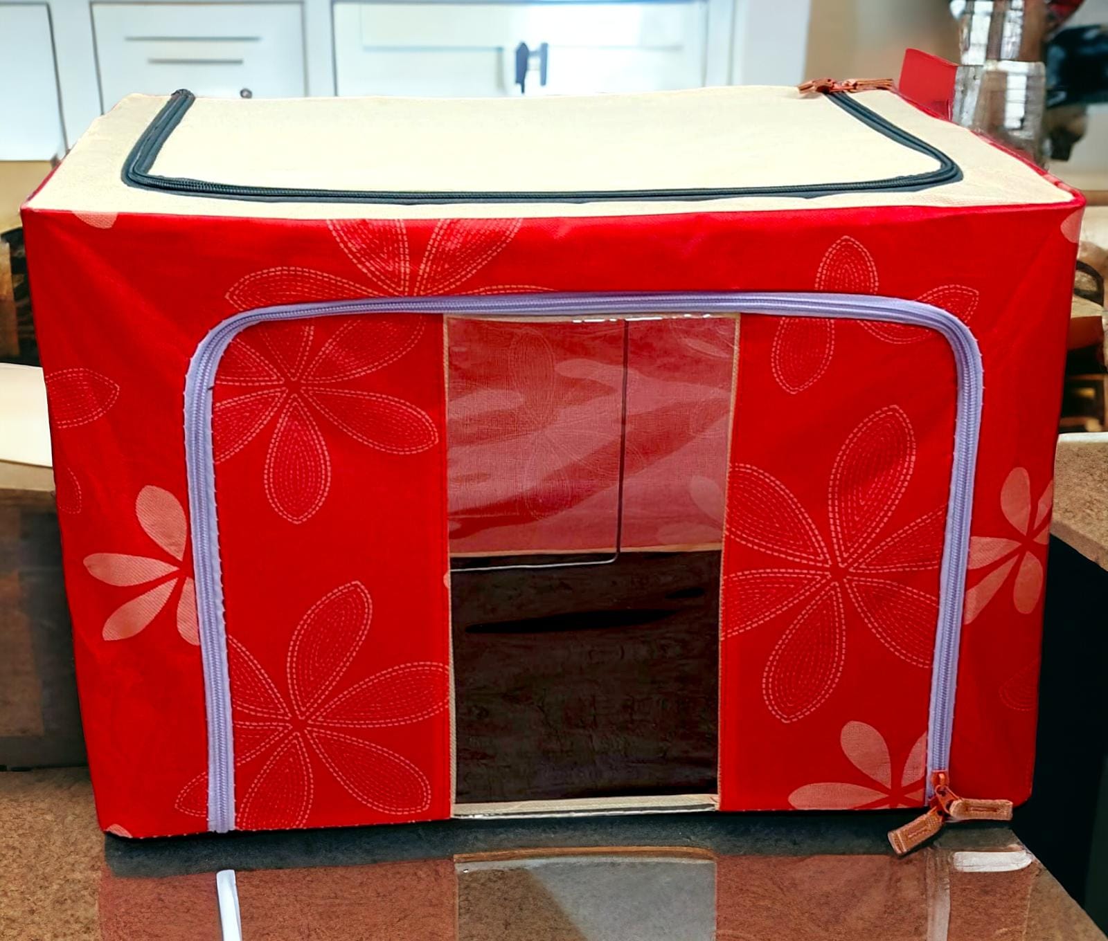 Red floral patterned fabric storage box with light purple zippers, bold and functional design.