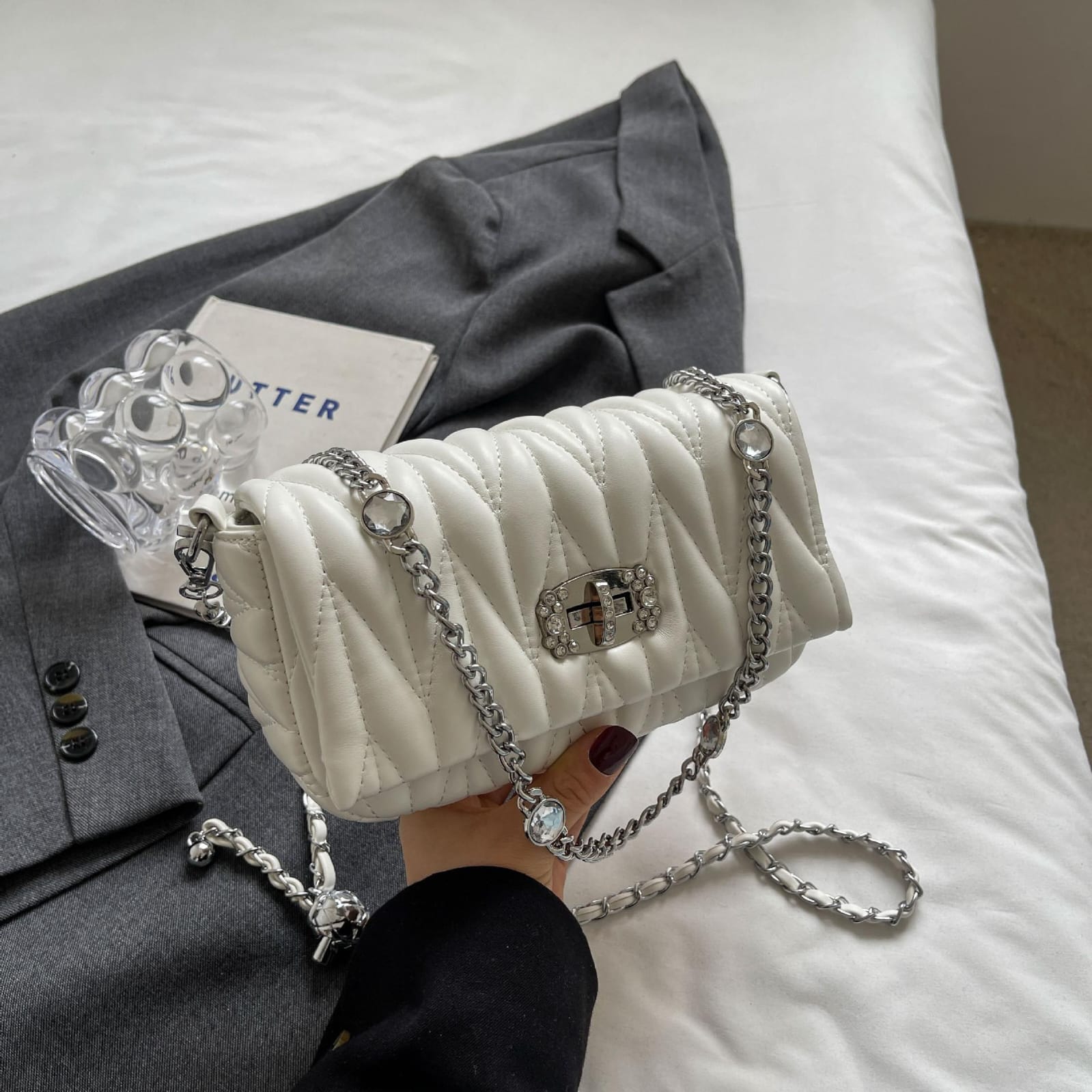 TRENDBUY Premium Quilted Sling Bag in cream white, displayed on a grey blazer, highlighting its elegant chain strap and embellished lock.